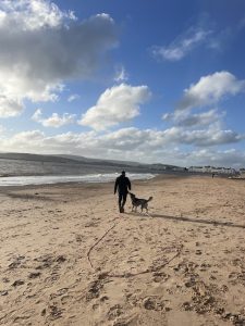 chris hull and his dog on a beach near exeter